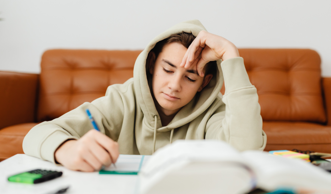 girl in a hooded jacket studying
